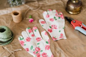 Garden gloves with floral print together with pruner and twine