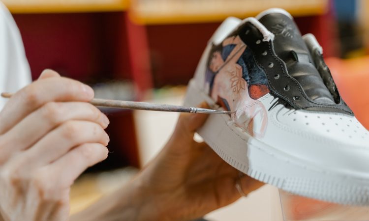 A Person Painting the White Sneaker