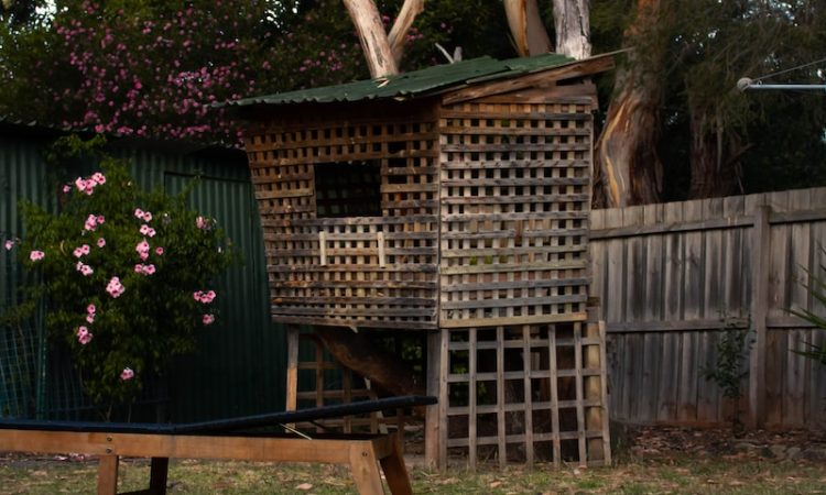 a wooden bench sitting in the middle of a yard